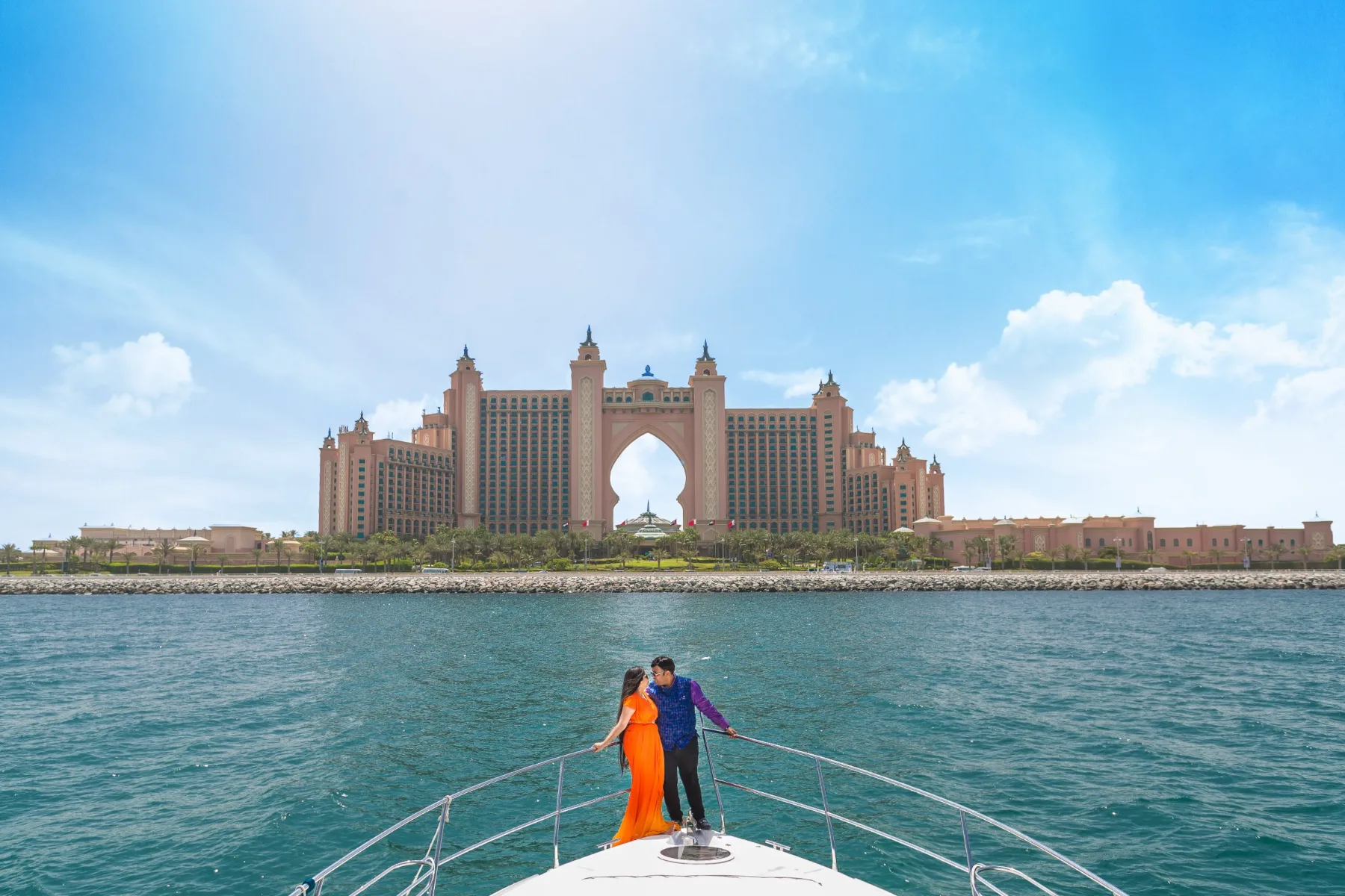 Pre-wedding portrait of a couple standing on a boat off the coast of Dubai, United Arab Emirates