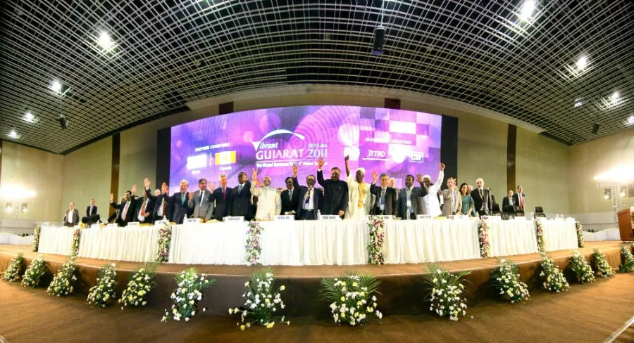 Dignitaries on stage during a panel session at a government investor summit in Gandhinagar